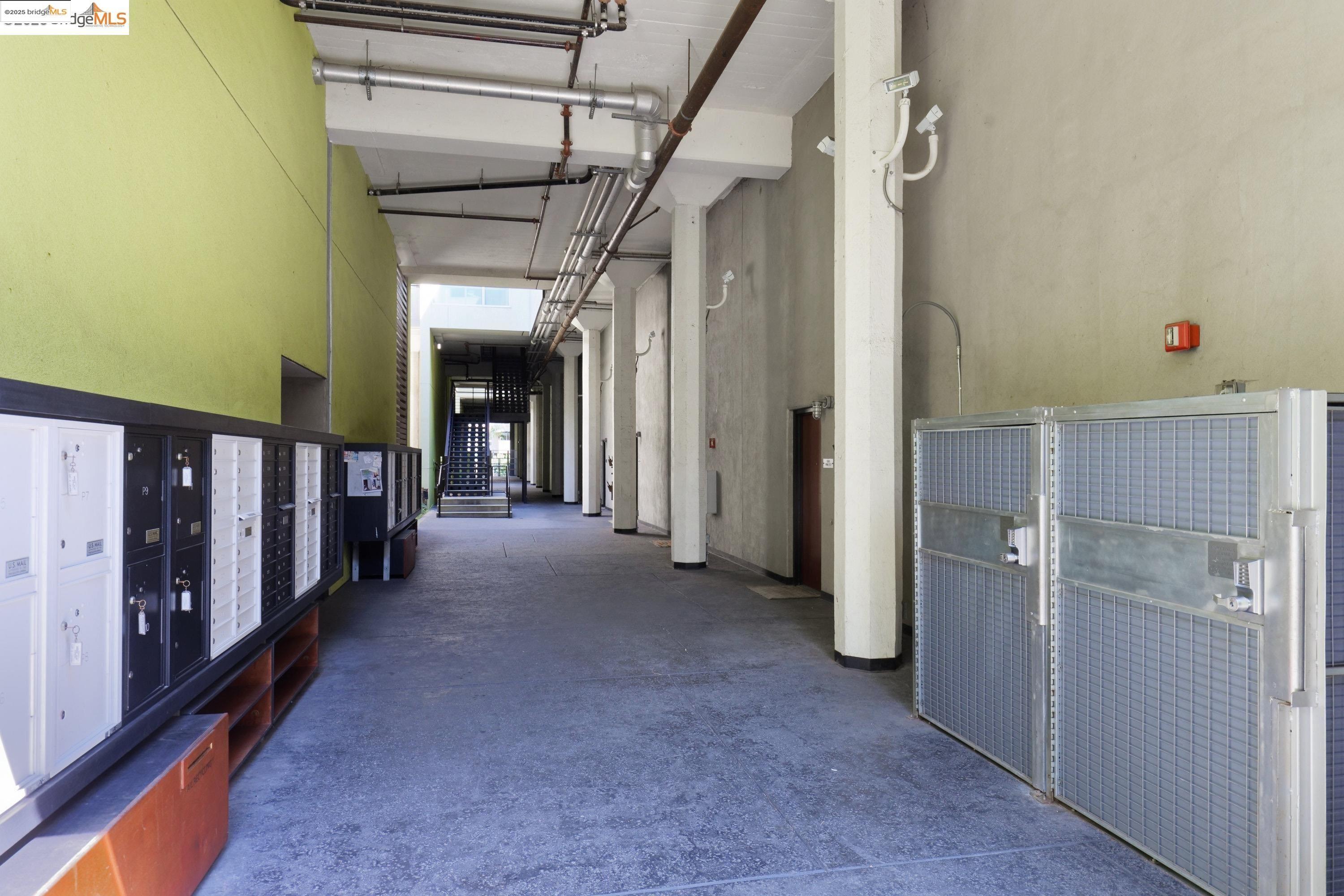 1201 Pine Street, Unit 315 Oakland, CA 94607 - Photo 32 of 41 Corridor featuring a towering ceiling and mail area