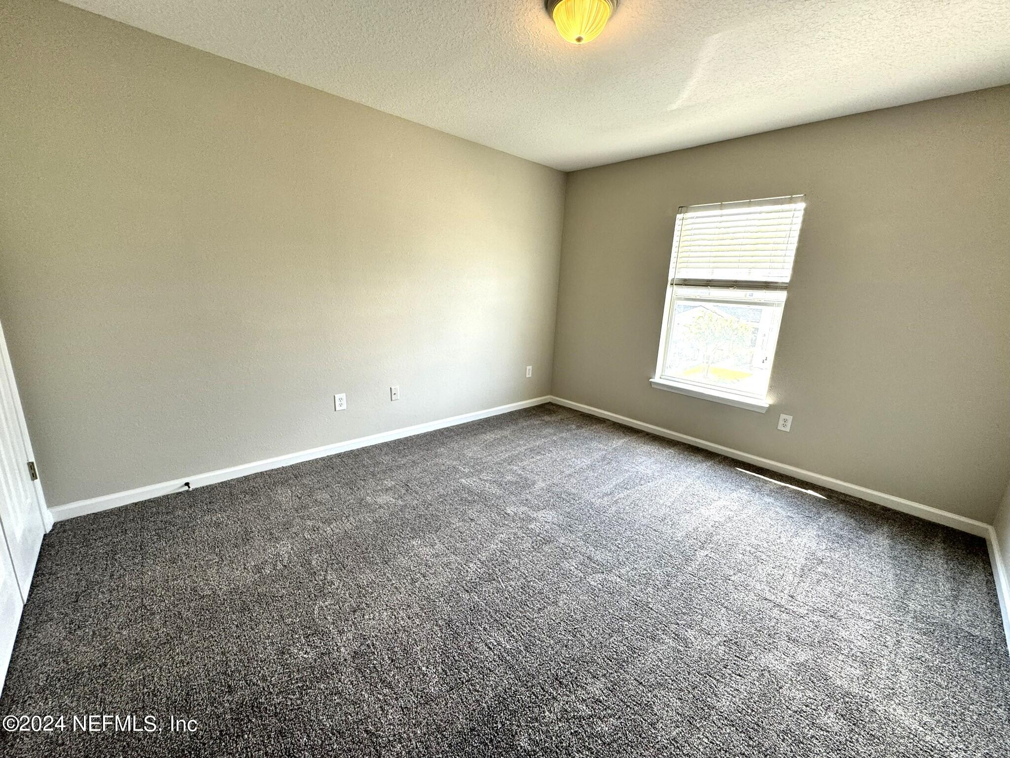 1500 Calming Water Drive, Unit 1003 Fleming Island, FL 32003 - Photo 11 of 13 an empty room with a window