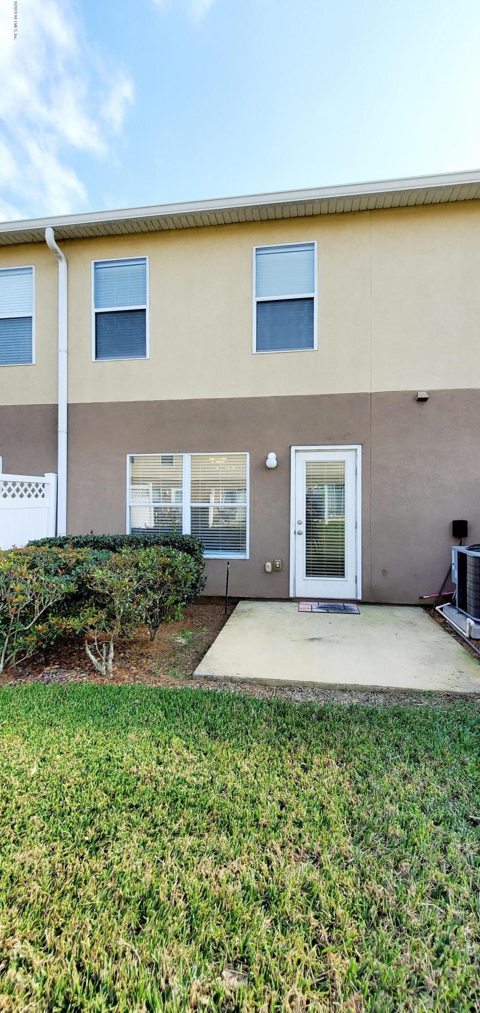 1500 Calming Water Drive, Unit 1003 Fleming Island, FL 32003 - Photo 13 of 13 a front view of a house with a yard and garage