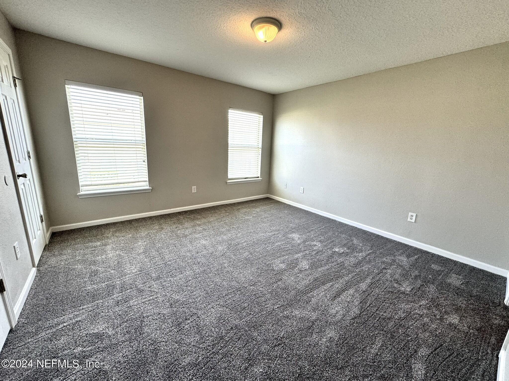 1500 Calming Water Drive, Unit 1003 Fleming Island, FL 32003 - Photo 4 of 13 an empty room with a window