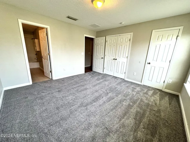 a view of an empty room and a window