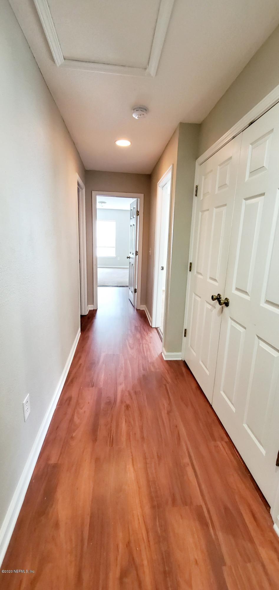 1500 Calming Water Drive, Unit 1003 Fleming Island, FL 32003 - Photo 7 of 13 a view of a hallway with wooden floor