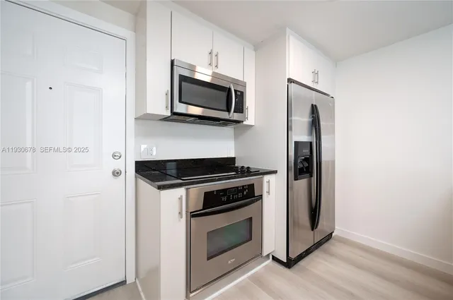 a kitchen with a stove and a microwave