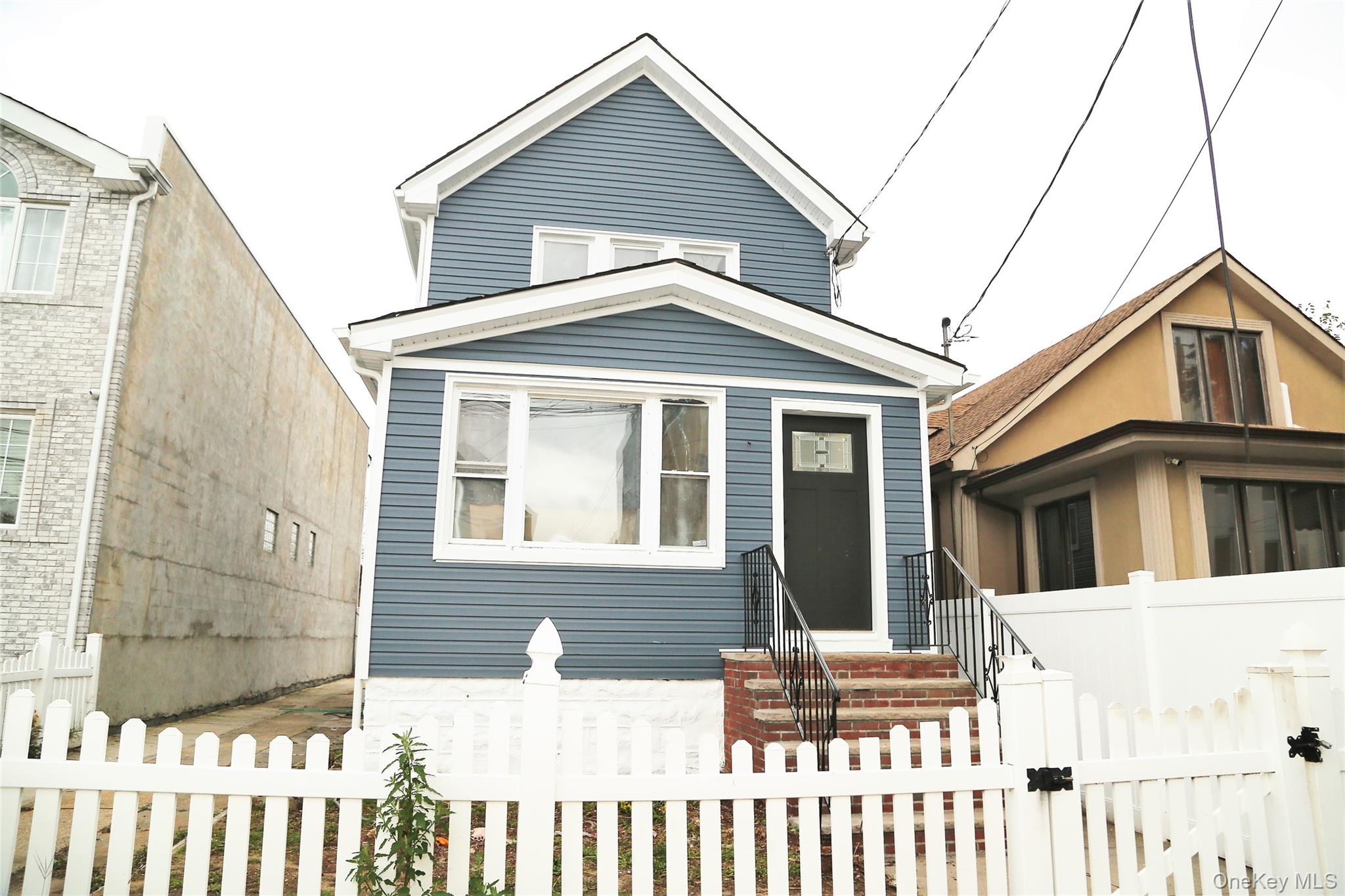 a front view of a house with a fence