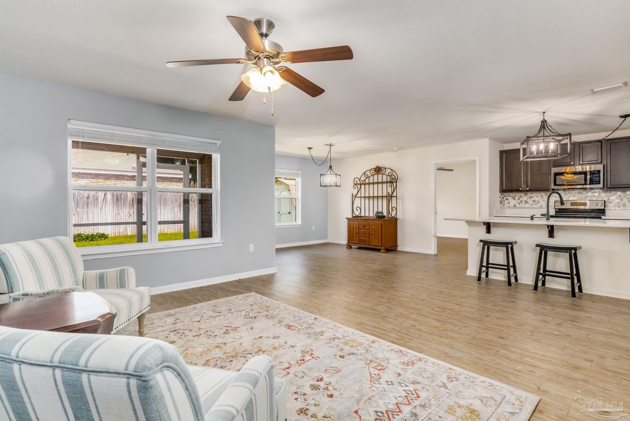 4706 Apple Field Way Milton, FL 32571 - Photo 12 of 52 a living room with furniture and a kitchen