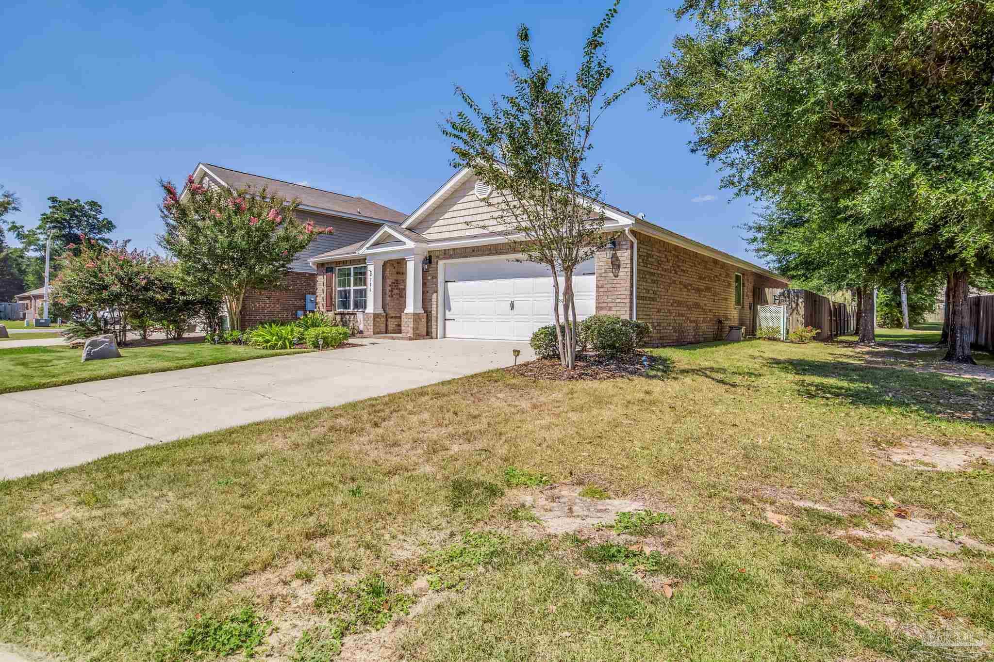 4706 Apple Field Way Milton, FL 32571 - Photo 2 of 52 a house with trees in the background