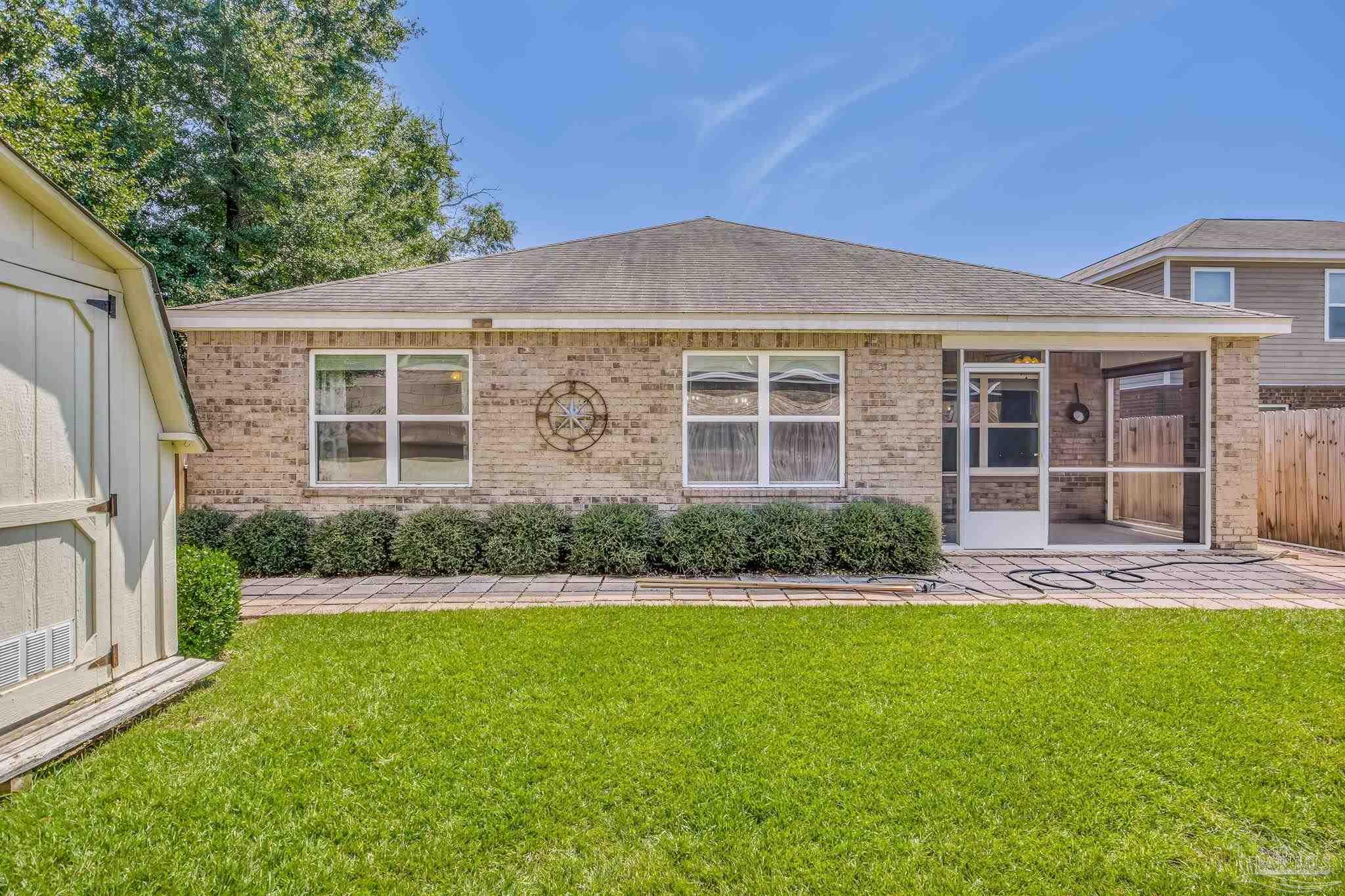 4706 Apple Field Way Milton, FL 32571 - Photo 24 of 52 a front view of a house with a yard and garage