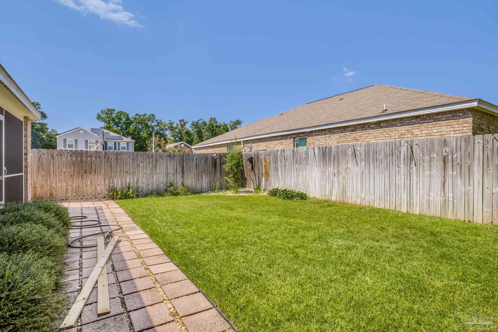 4706 Apple Field Way Milton, FL 32571 - Photo 26 of 52 a backyard of a house with lots of green space