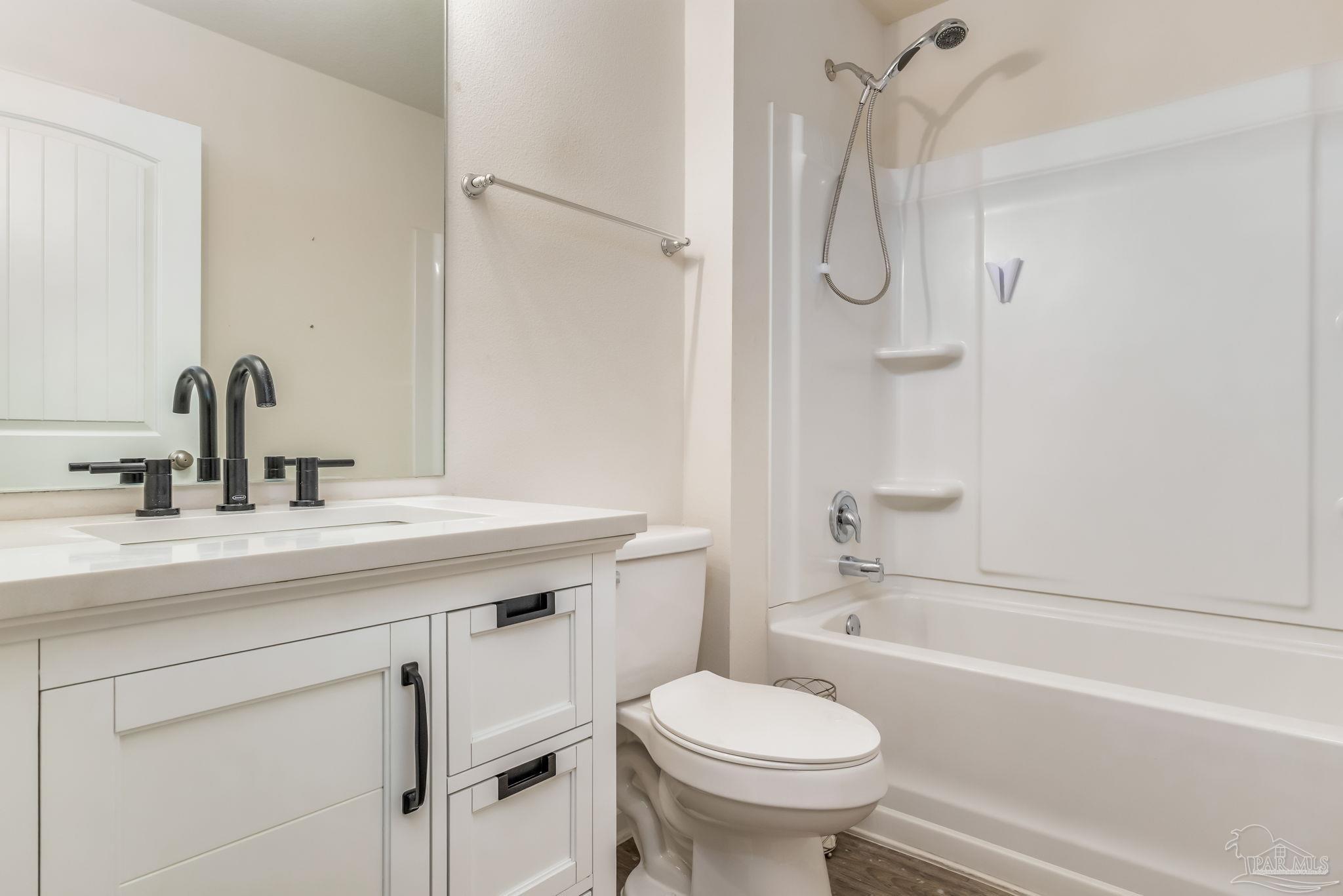 4706 Apple Field Way Milton, FL 32571 - Photo 32 of 52 a bathroom with a sink toilet and shower