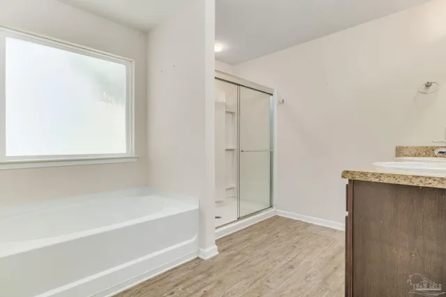 a bathroom with a tub shower and a sink