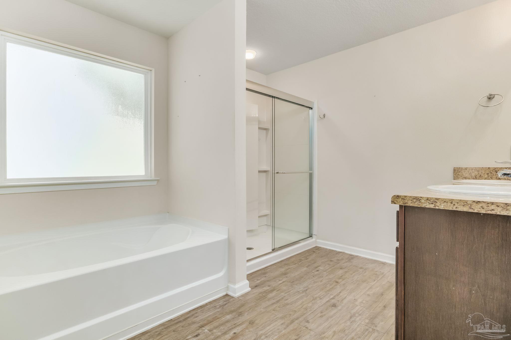 4706 Apple Field Way Milton, FL 32571 - Photo 43 of 52 a bathroom with a bathtub and a shower