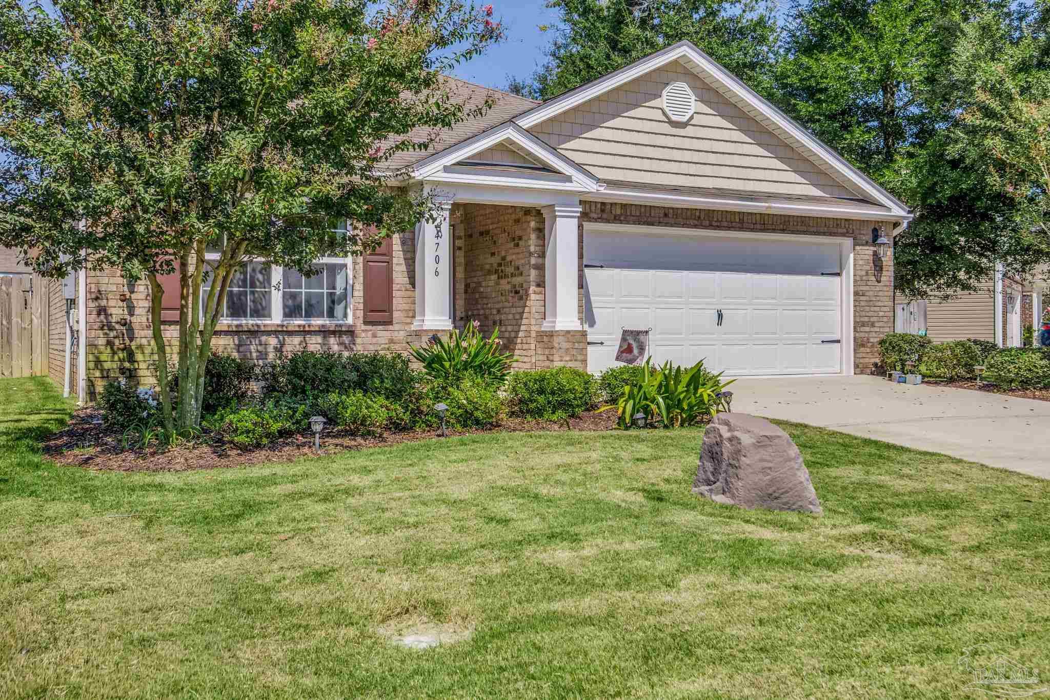 4706 Apple Field Way Milton, FL 32571 - Photo 47 of 52 a front view of a house with a yard and garage