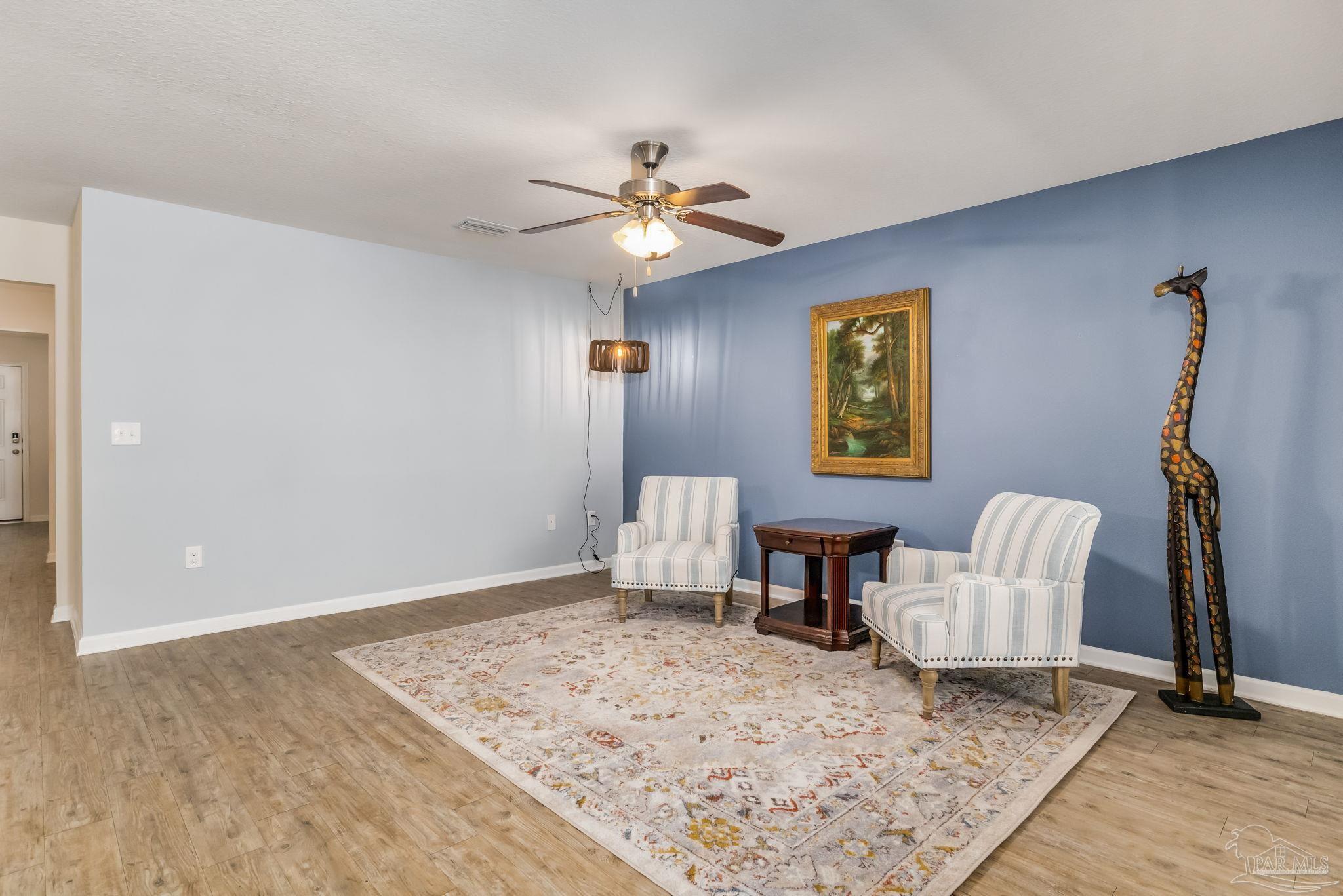 4706 Apple Field Way Milton, FL 32571 - Photo 8 of 52 a living room with furniture and a rug