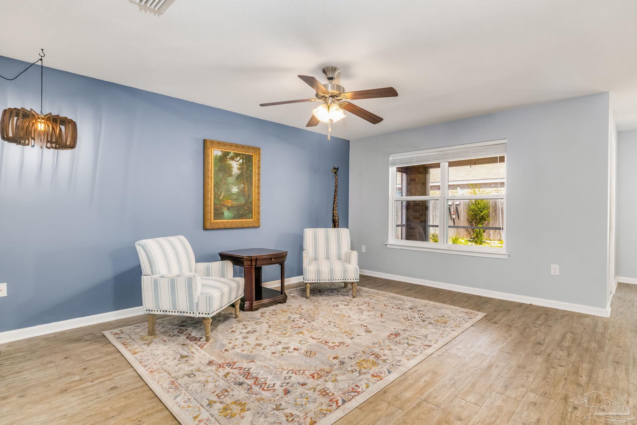 4706 Apple Field Way Milton, FL 32571 - Photo 9 of 52 a view of livingroom with furniture window and wooden floor