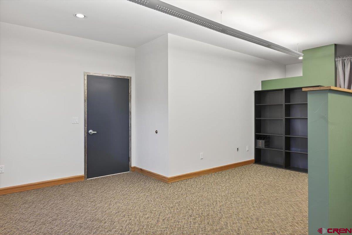 653 North Cora Street, Unit 201 Ridgway, CO 81432 - Photo 13 of 18 a view of an empty room with closet and wooden shelves
