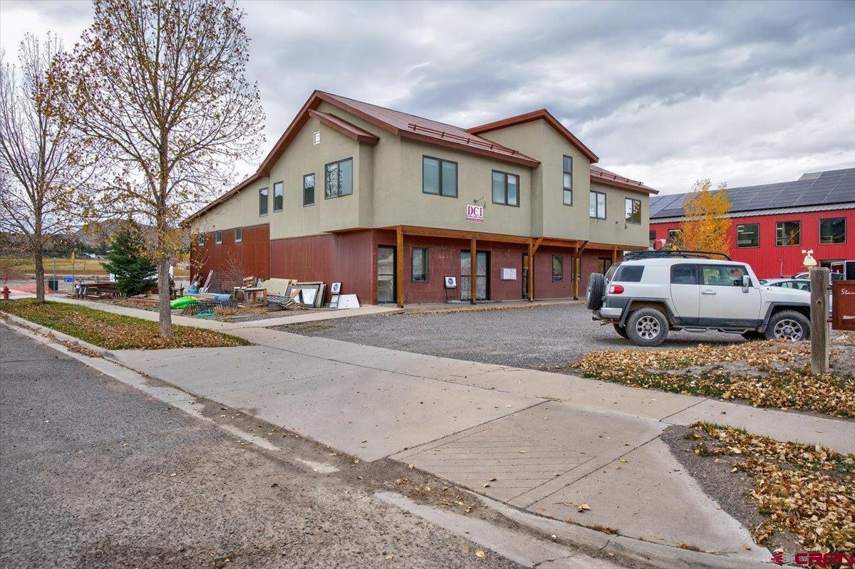 653 North Cora Street, Unit 201 Ridgway, CO 81432 - Photo 3 of 18 a front view of a building with cars parked