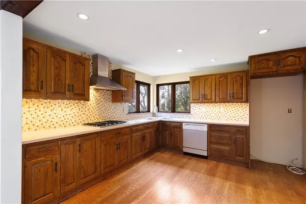 a large kitchen with granite countertop a large counter top and sink
