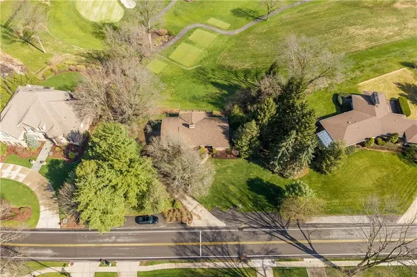 an aerial view of residential houses with outdoor space