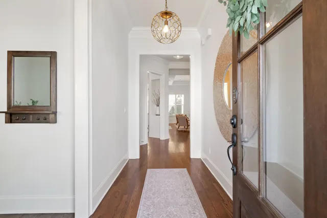 a living room with furniture a fireplace and a large window