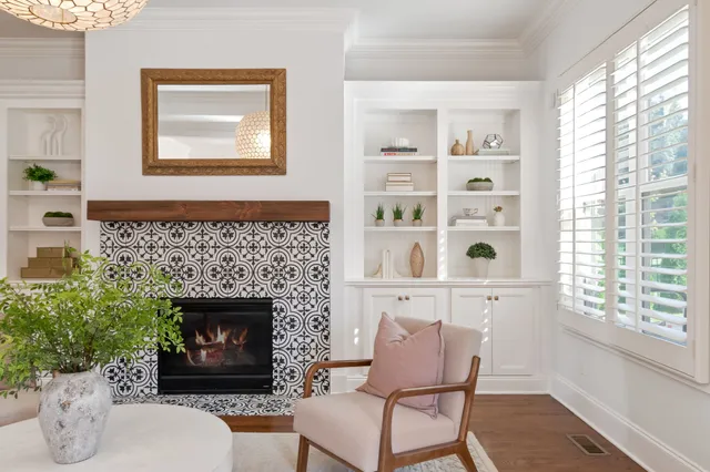 a bedroom with a bed a window and a fireplace