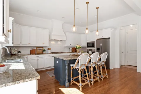 a bathroom with a granite countertop sink toilet and a mirror