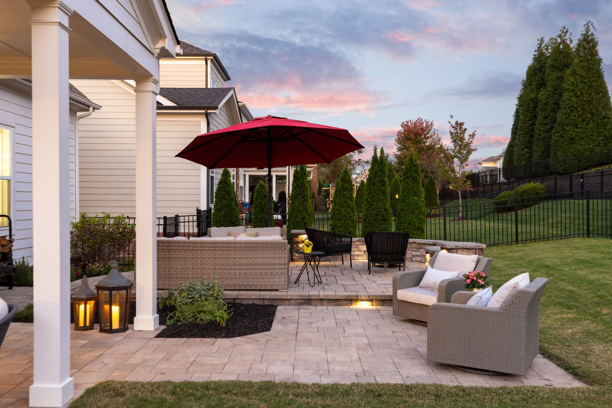 463 Avon River Road Franklin, TN 37064 - Photo 69 of 91 a view of a patio with couches and table under an umbrella with a garden