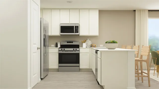 a kitchen with stainless steel appliances a stove microwave and refrigerator