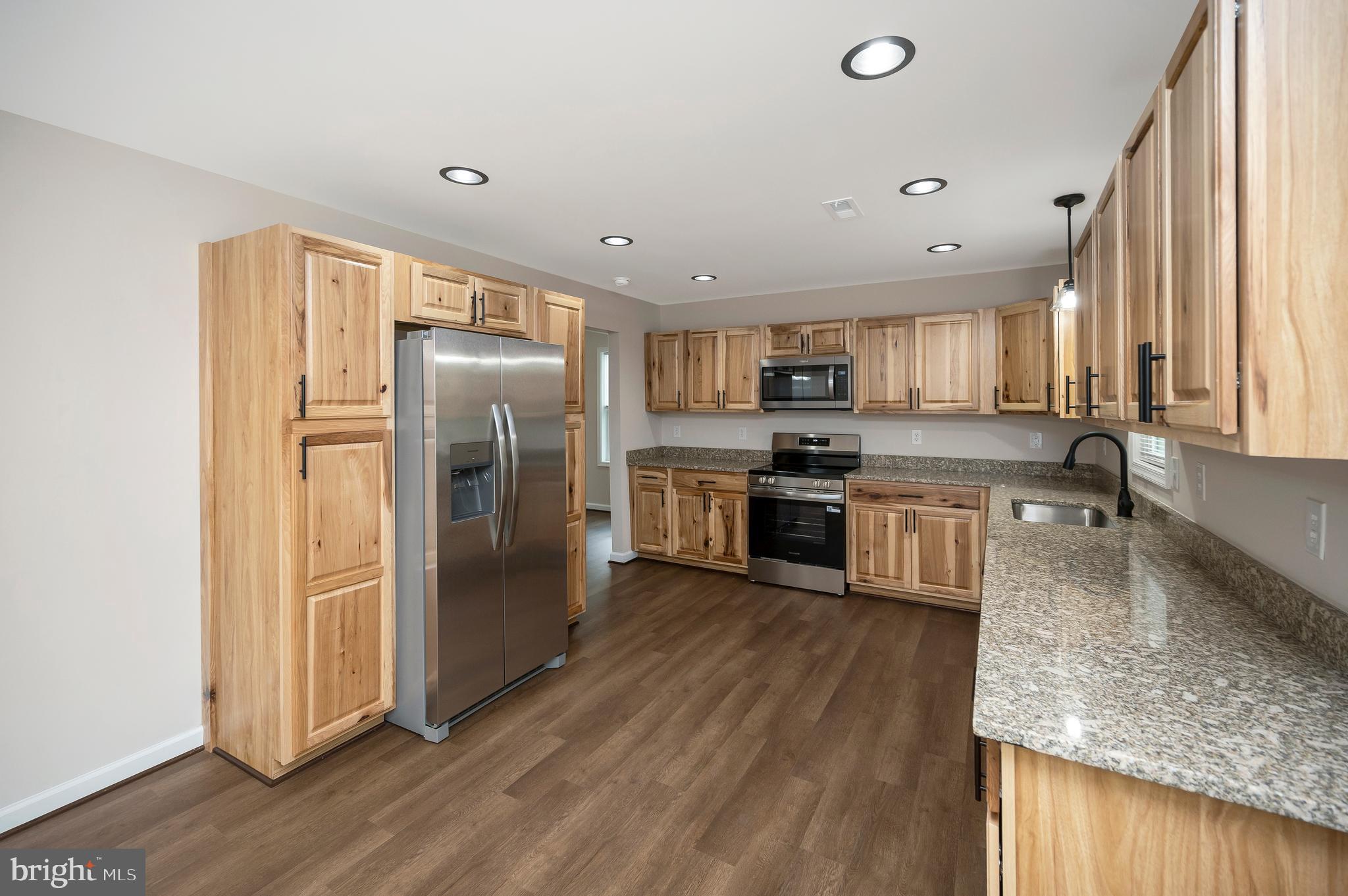 14169 Silver Hill Road Sumerduck, VA 22742 - Photo 12 of 40 a kitchen with stainless steel appliances granite countertop a refrigerator a stove and a sink