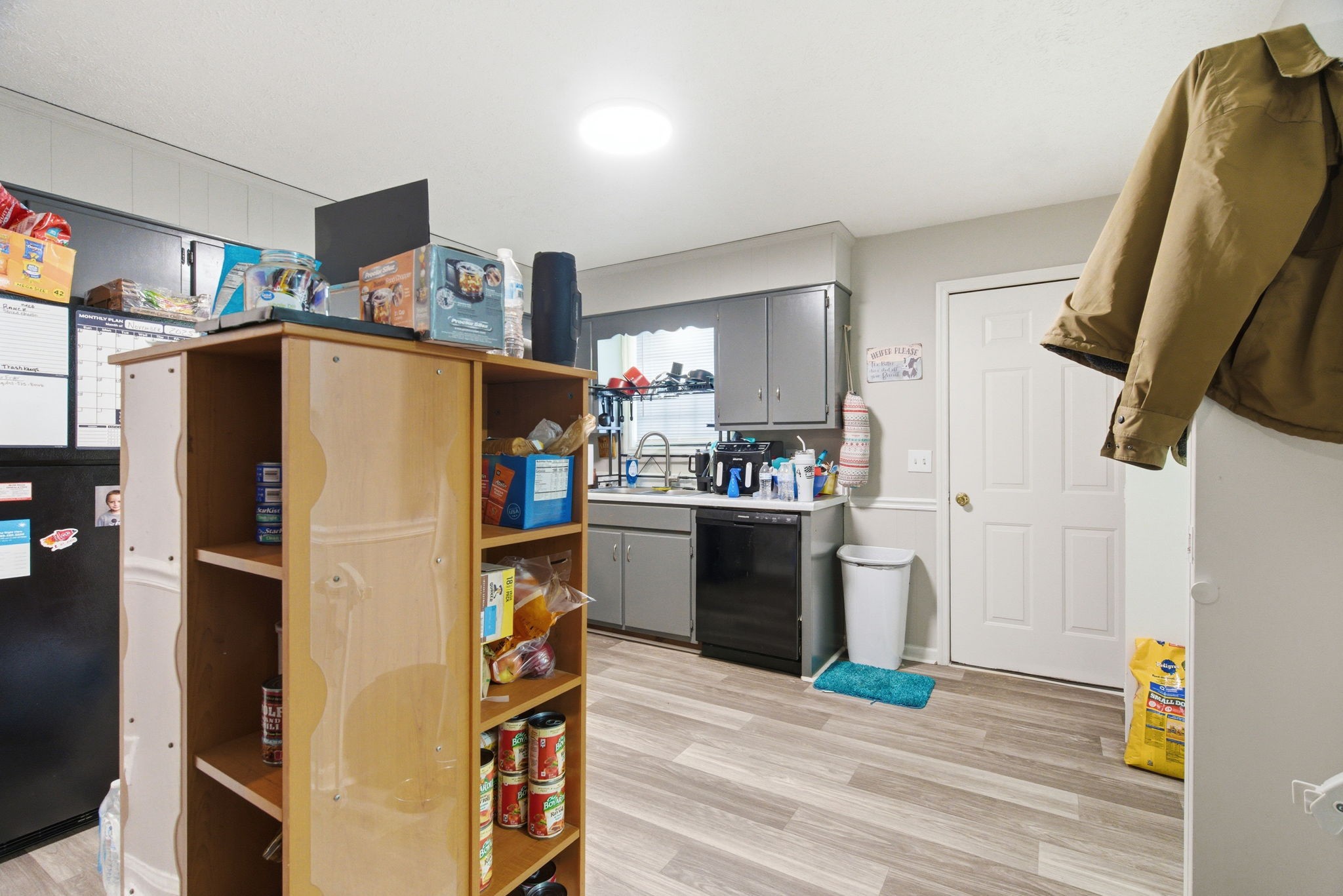 111 Gayla Court Portland, TN 37148 - Photo 32 of 47 a kitchen with stainless steel appliances a refrigerator and a wooden floor