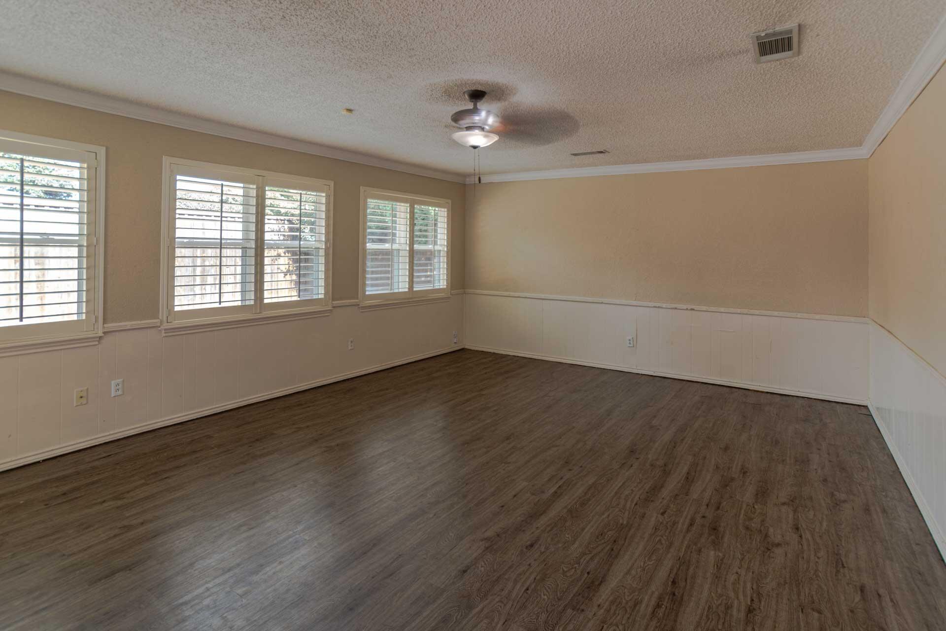 3312 77th Street Lubbock, TX 79423 - Photo 15 of 30 an empty room with wooden floor and windows