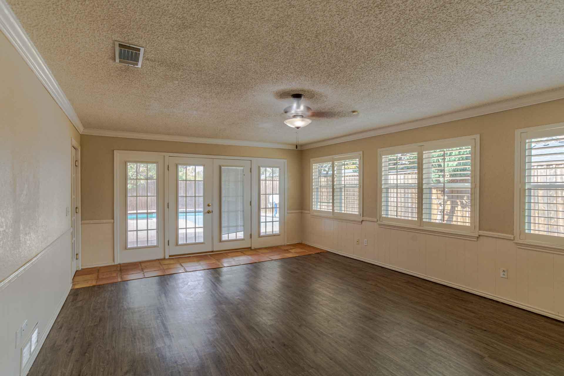 3312 77th Street Lubbock, TX 79423 - Photo 16 of 30 a view of an empty room with wooden floor and a window