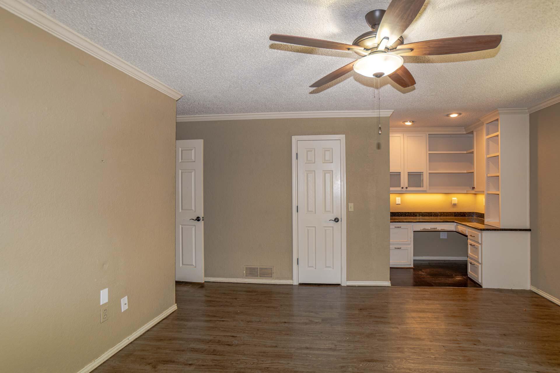 3312 77th Street Lubbock, TX 79423 - Photo 19 of 30 a view of a livingroom with a flat screen tv and fireplace