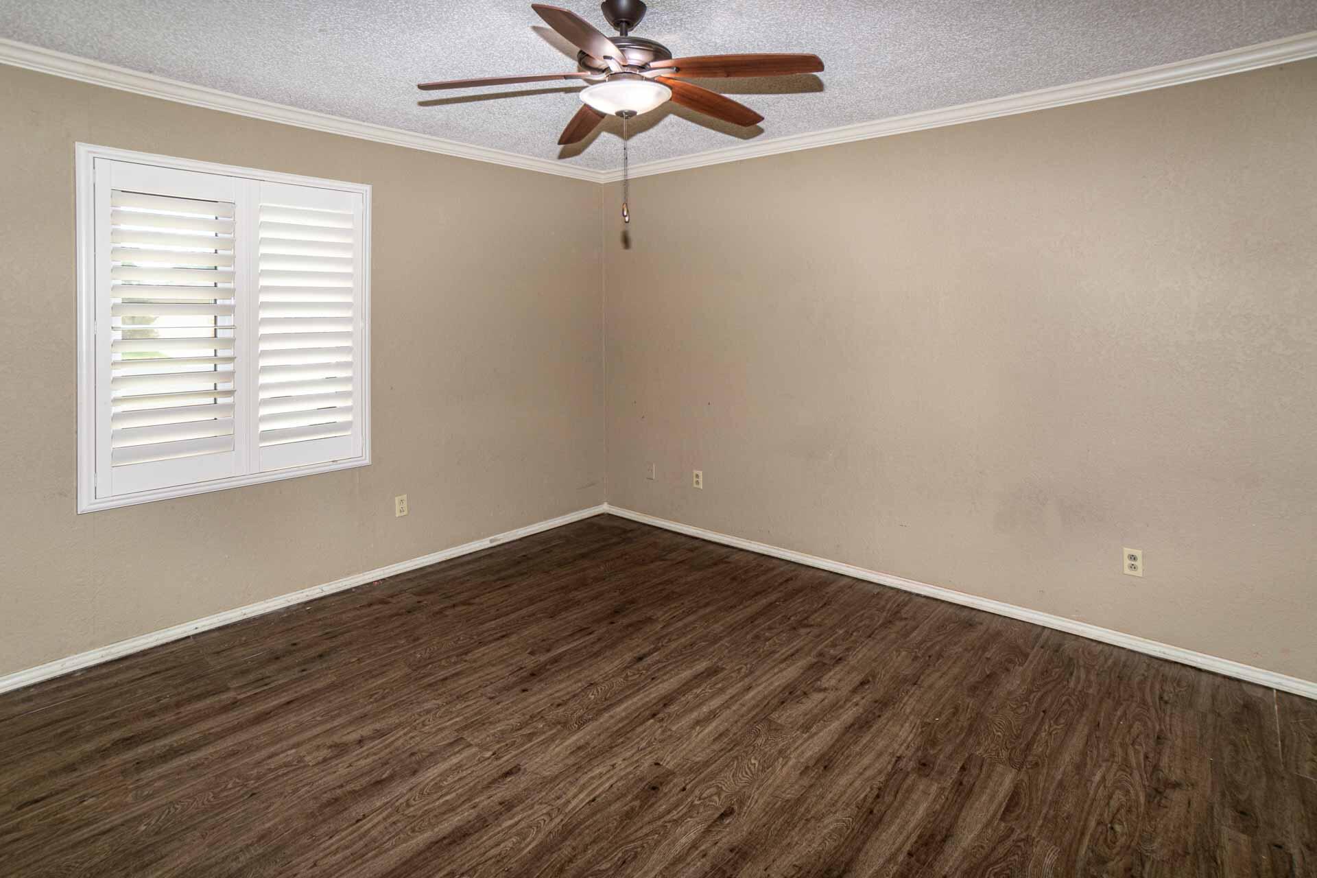 3312 77th Street Lubbock, TX 79423 - Photo 23 of 30 wooden floor in an empty room with a window