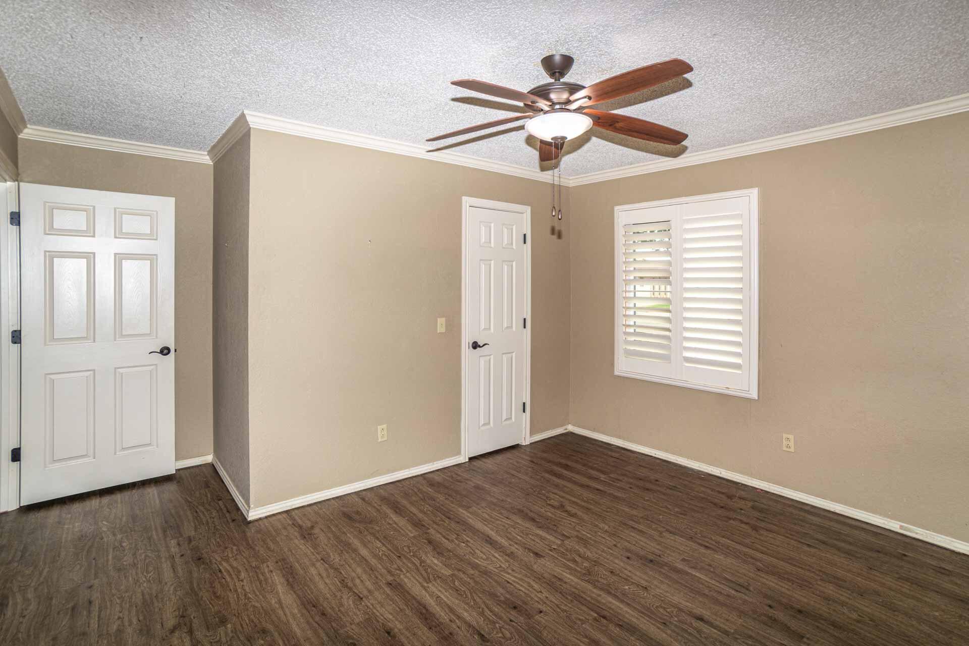 3312 77th Street Lubbock, TX 79423 - Photo 25 of 30 a view of a big room with wooden floor and windows
