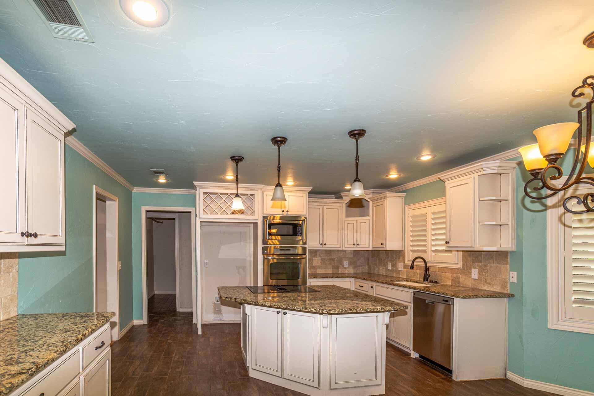 3312 77th Street Lubbock, TX 79423 - Photo 3 of 30 a kitchen with stainless steel appliances granite countertop a sink and a refrigerator