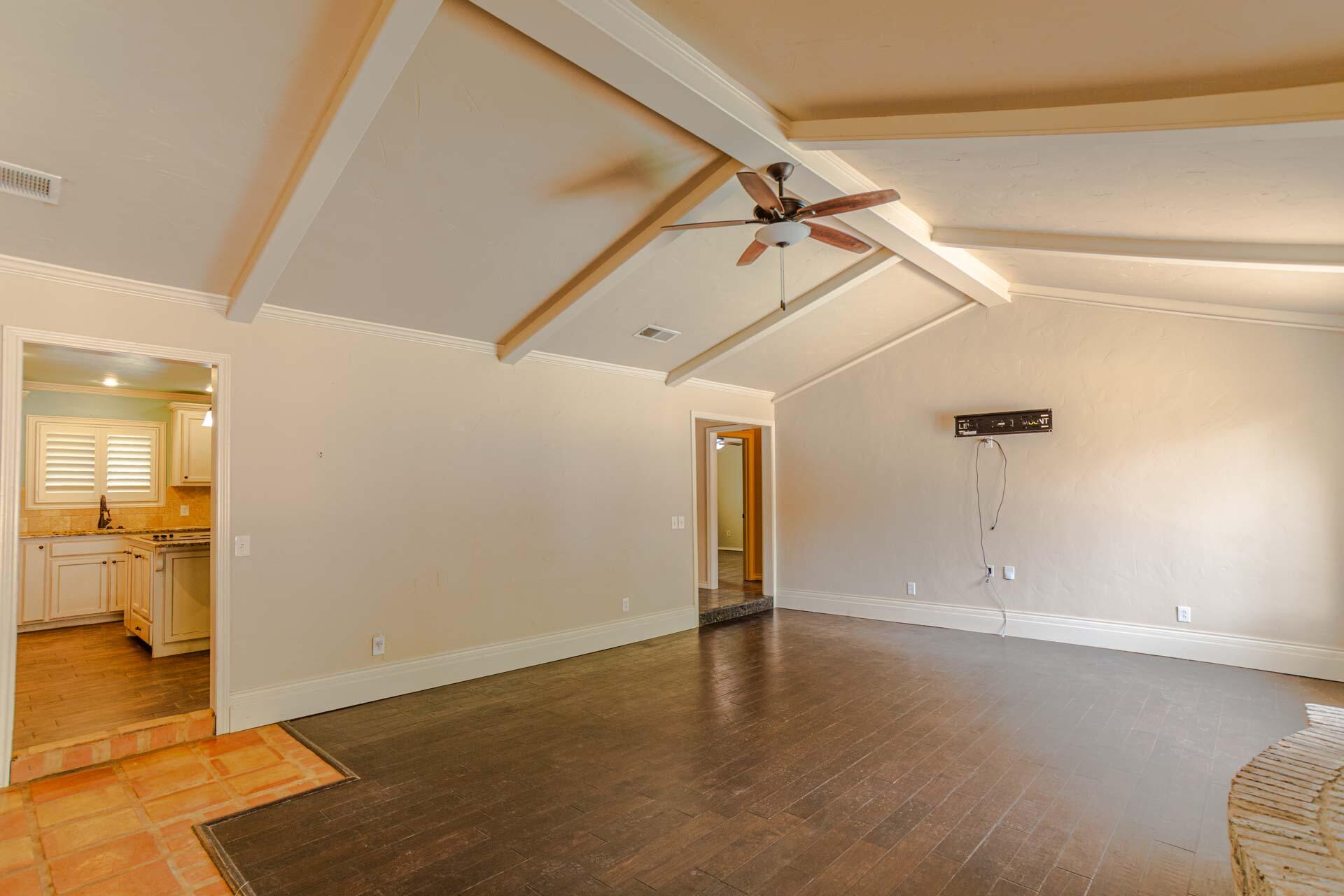 3312 77th Street Lubbock, TX 79423 - Photo 5 of 30 an empty room with wooden floor and windows
