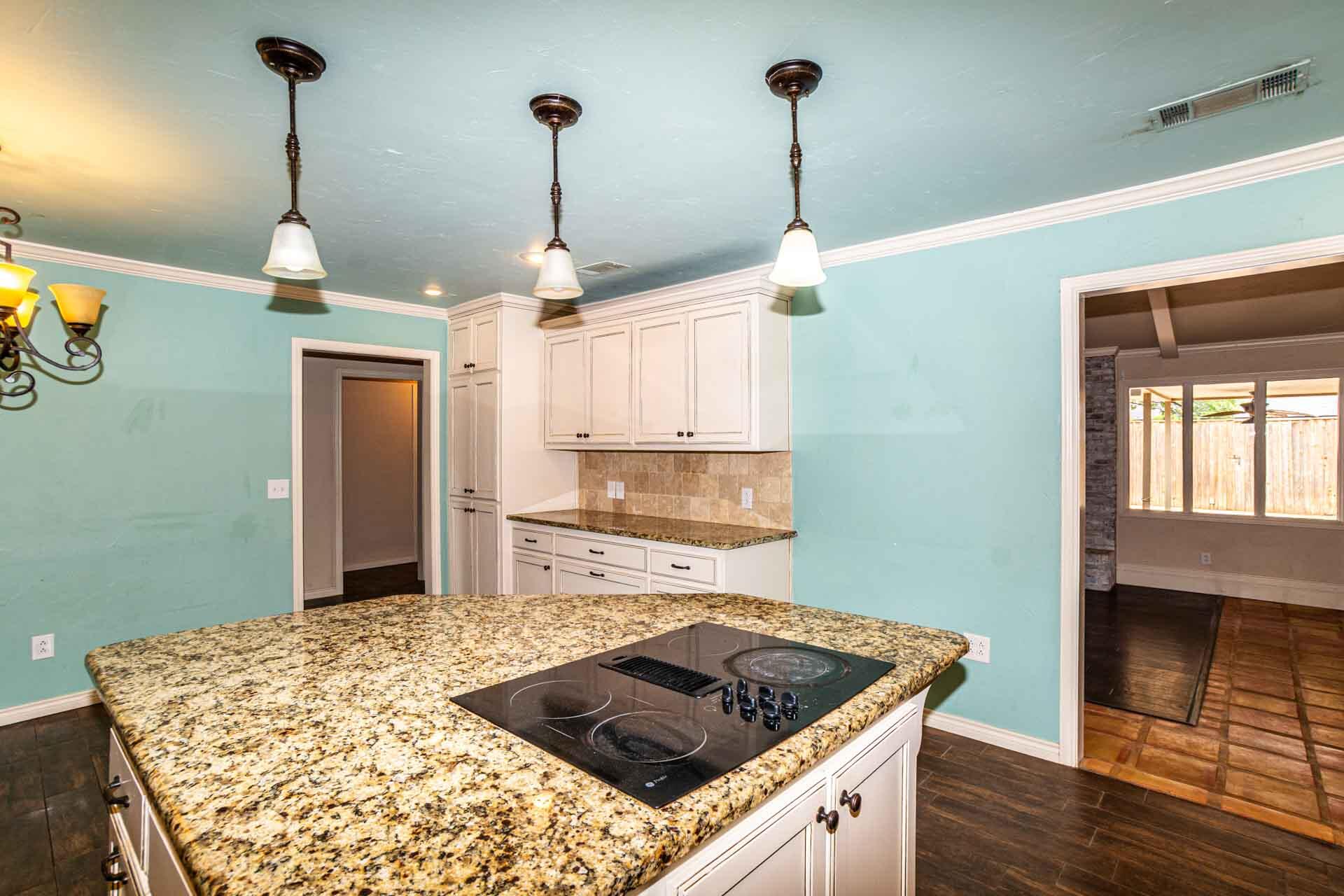 3312 77th Street Lubbock, TX 79423 - Photo 10 of 30 a kitchen with a stove and a wooden floor