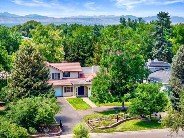an aerial view of a house with a yard and potted plants
