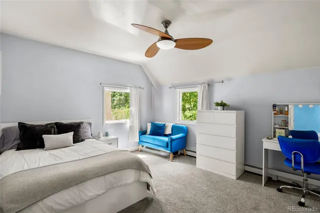 a bedroom with a bed and a couch