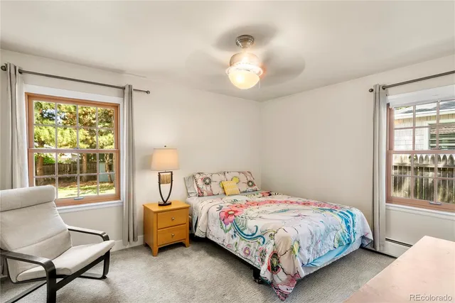 a bedroom with a bed chair and a window