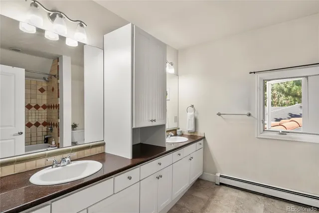 a bathroom with a granite countertop sink mirror and double