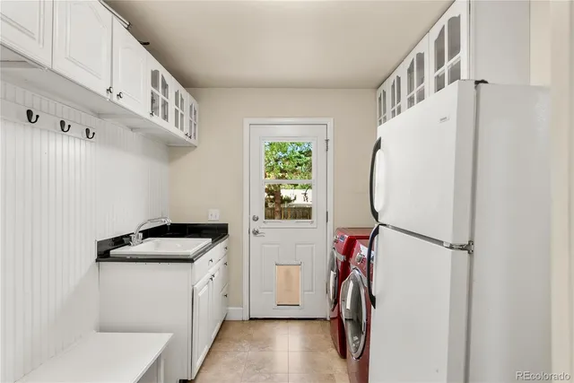 a utility room with multiple dryer and washer