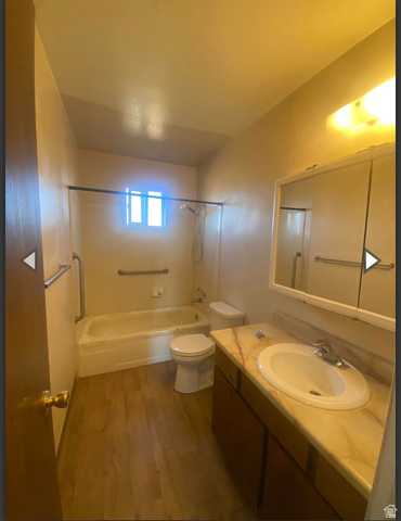 102 East Richelman Lane Wellington, UT 84542 - Photo 13 of 39 Full bathroom featuring dark wood-style flooring, vanity, and washtub / shower combination
