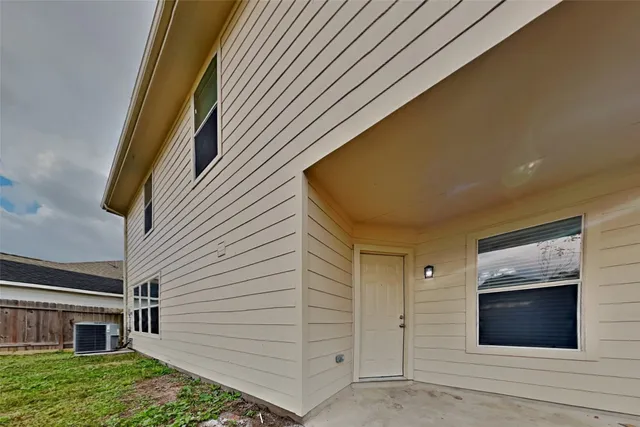 a view of a house with a door and wooden walls
