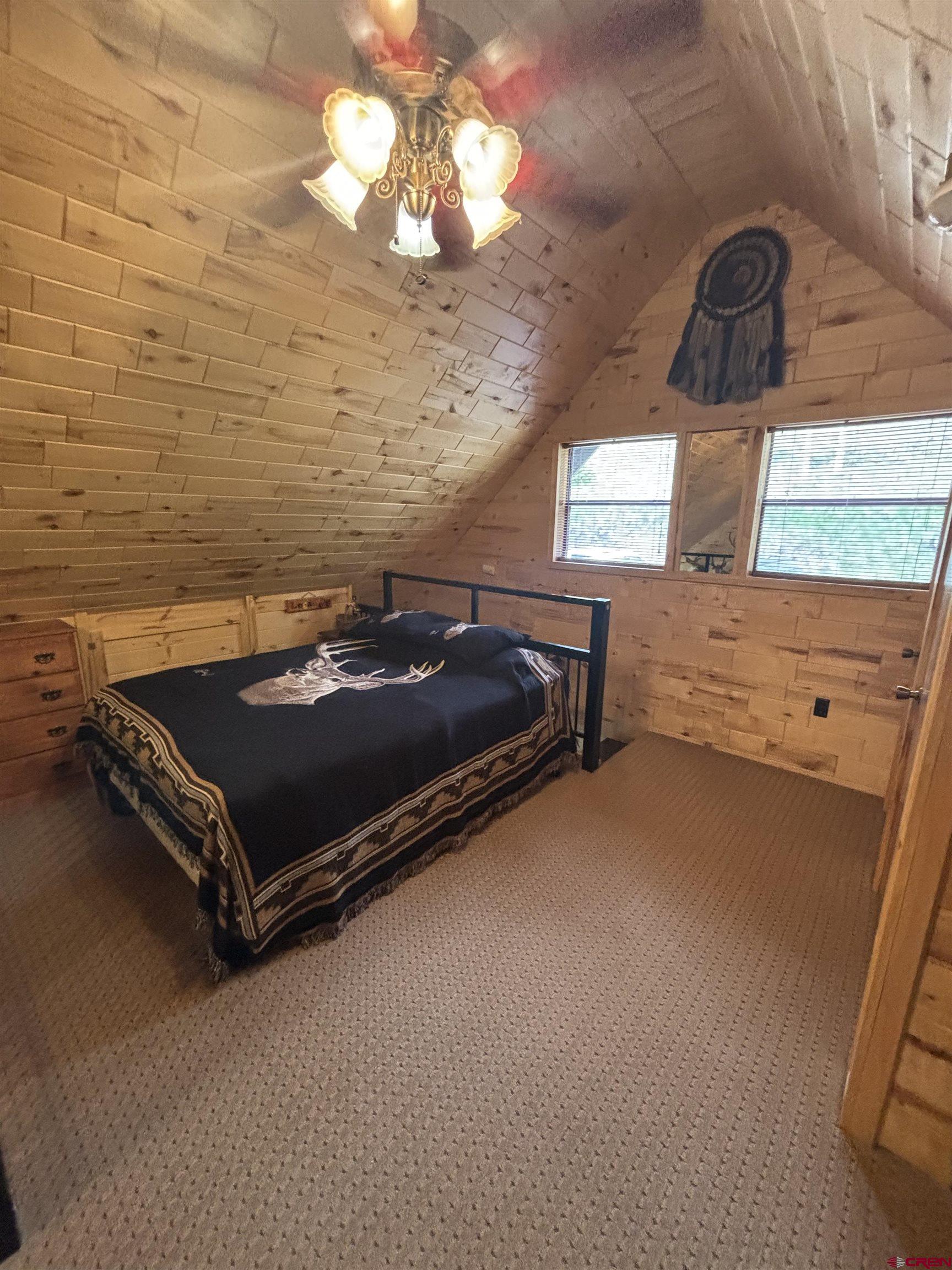 1113 Spring Street Del Norte, CO 81132 - Photo 33 of 43 a bedroom with a bed and a dresser