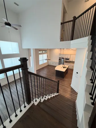 an empty room with a ceiling fan and windows