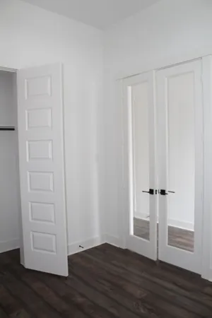 a view of wooden floor and windows in a room