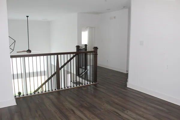 a view of a hallway with wooden floor