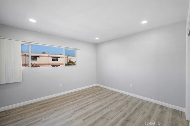 a view of a kitchen with wooden floor and entryway