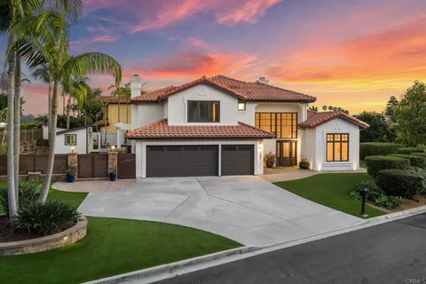 a front view of a house with a garden and yard